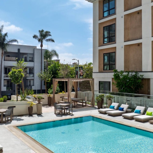 Resort-style swimming pool a pool with poolside seating
