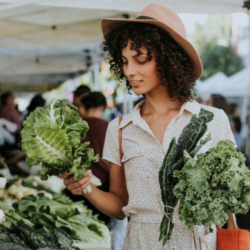 Find your perfect fit at LANA A woman holding a bunch of broccoli